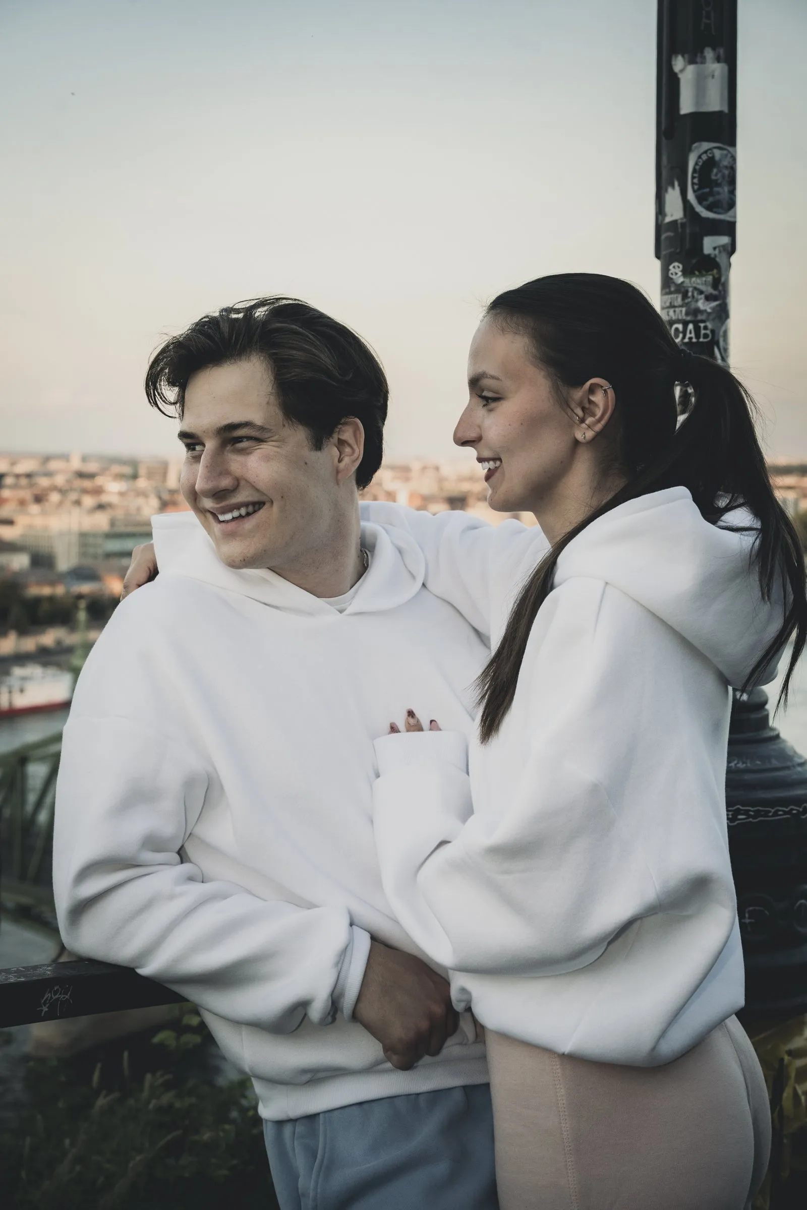 Two people in white custom Levacher hoodies in Budapest